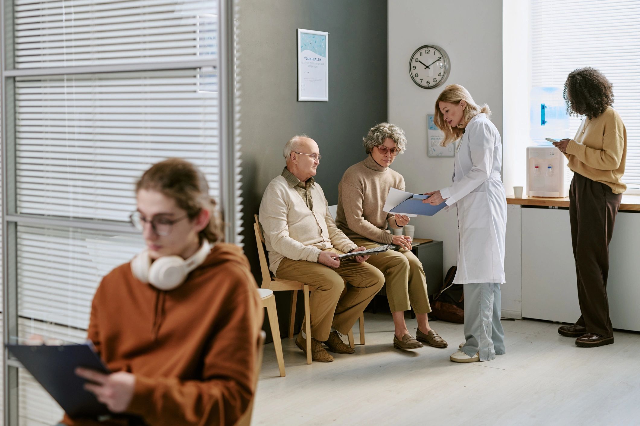 Doctor consulting with senior patients in a clinic