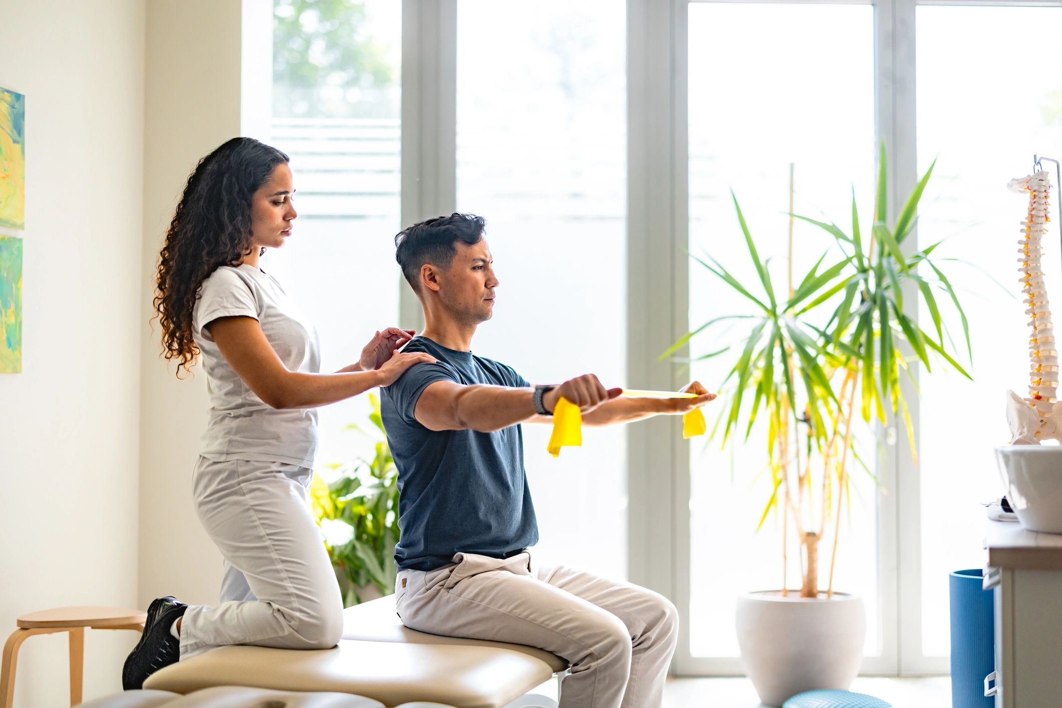 Therapist guiding a patient during a physiotherapy rehabilitation session